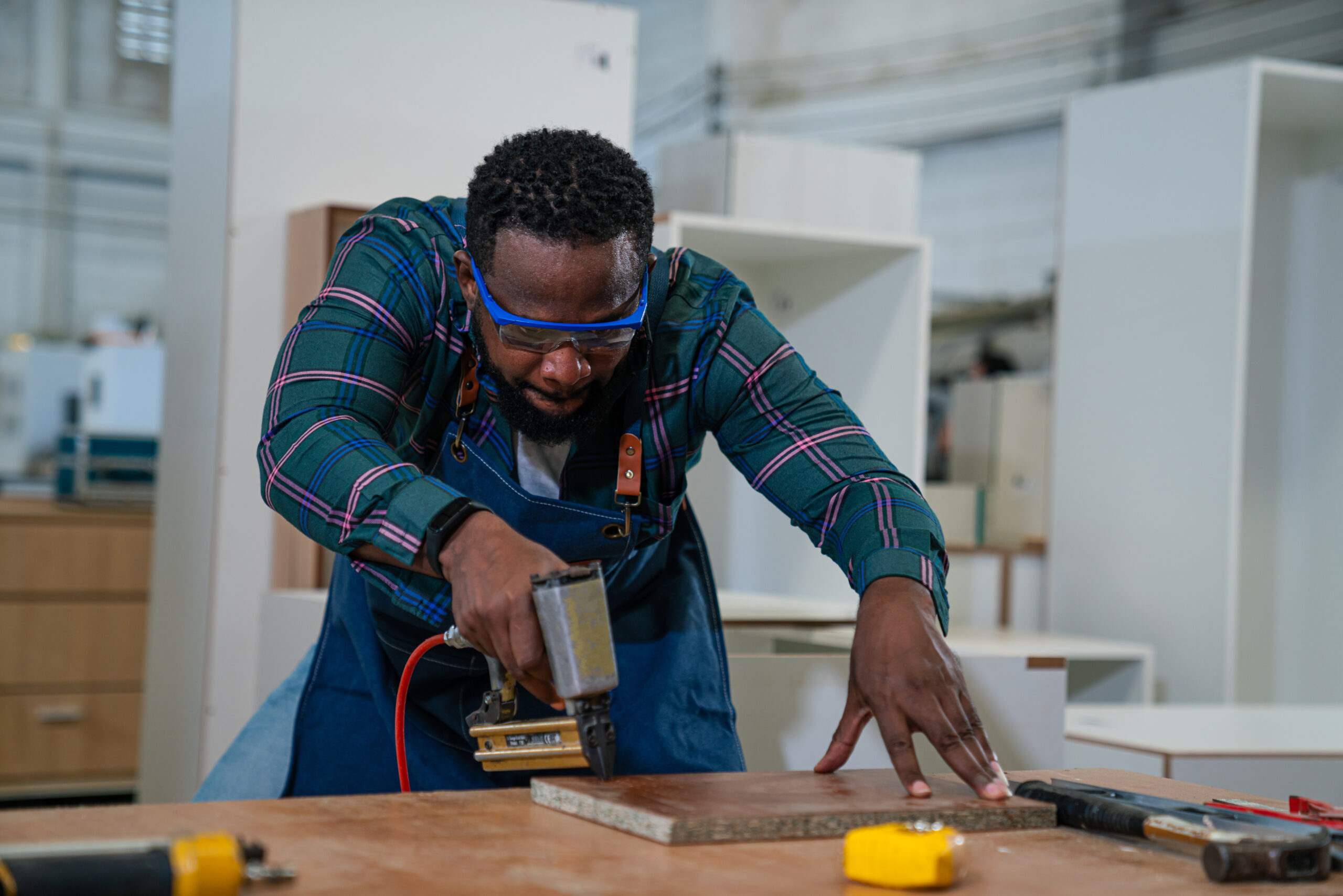Afro american craftsman working as carpenter in a carpentry work